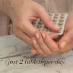 Hands holding a blister pack of tablets with the text “just 2 tablets per day”.