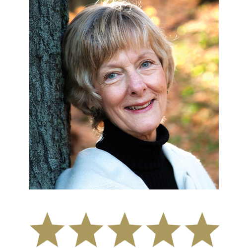 Older Woman smiling, against a tree with five stars beneath