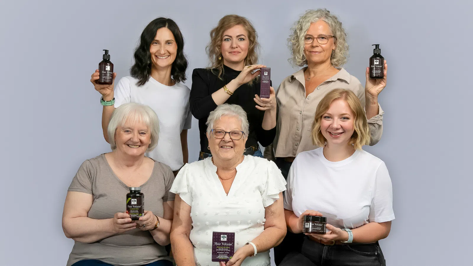 Six women smiling and holding products from the New Nordic Hair Volume™ Series