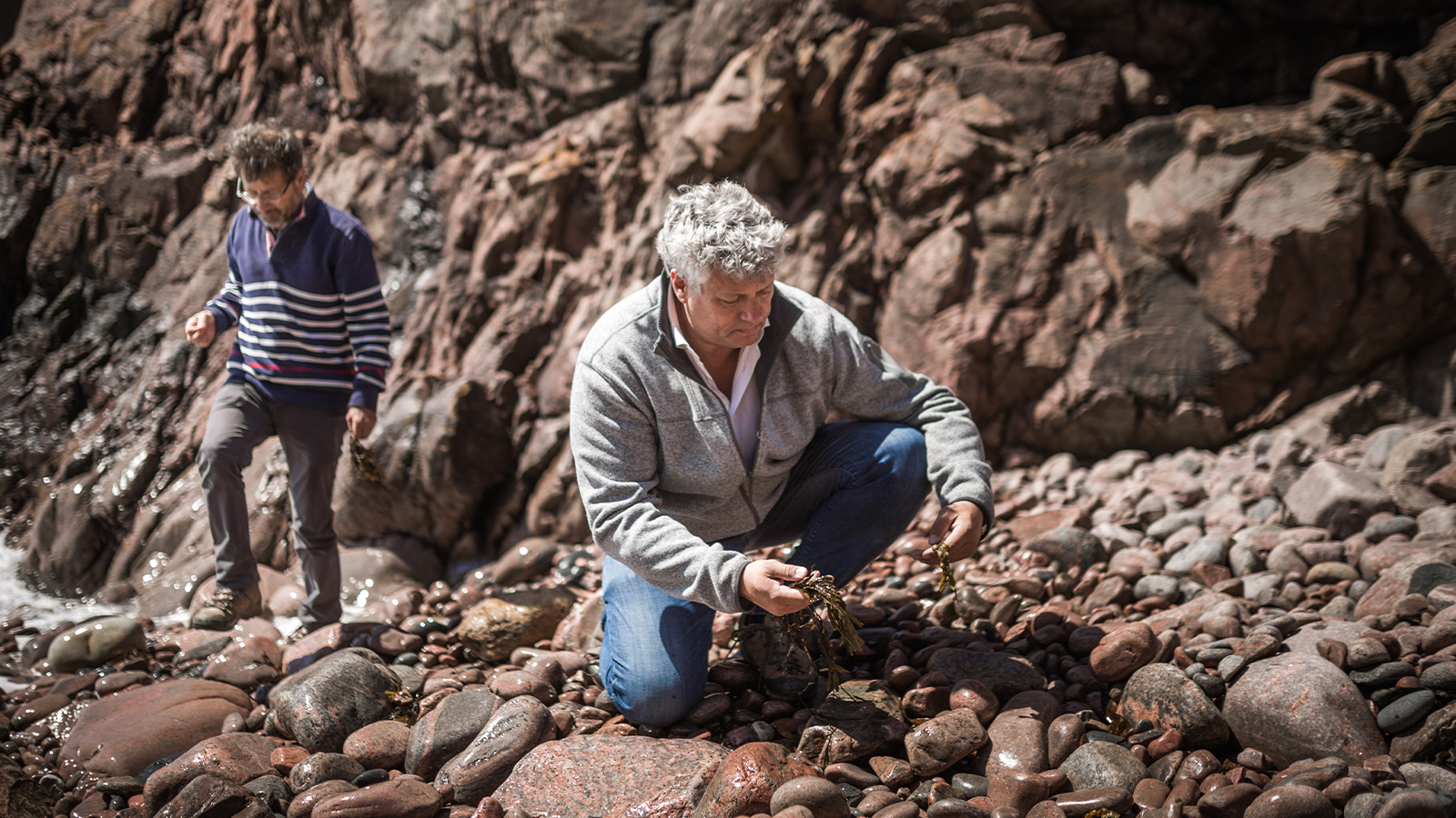 Healthy and Happy People Inspired the Foundation of New Nordic 7 Two men exploring nature, surrounded by rocky cliffs.