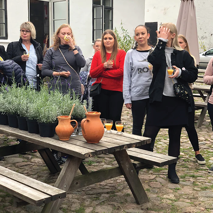 People attending a herbal school event, learning about and engaging with plants.