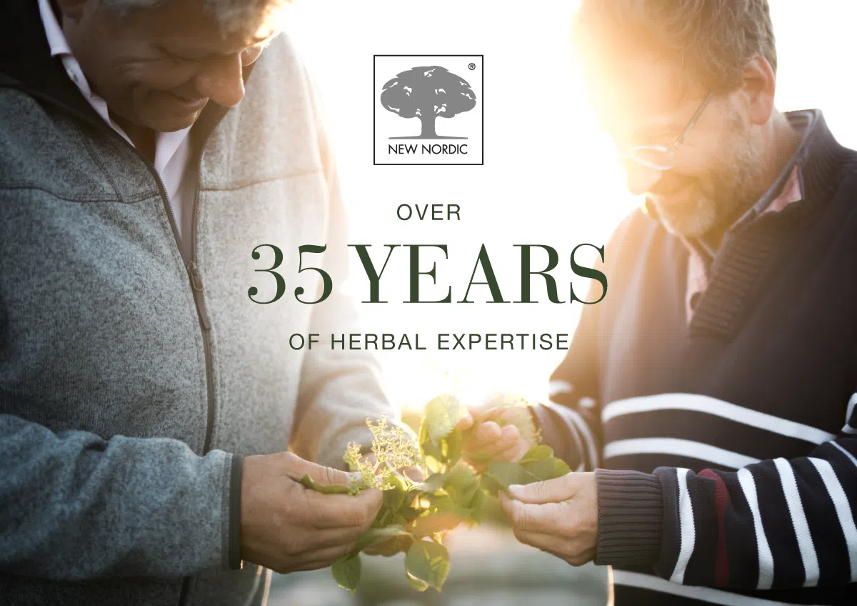 Two men examining herbs with New Nordic logo and text celebrating over 35 years of herbal expertise.